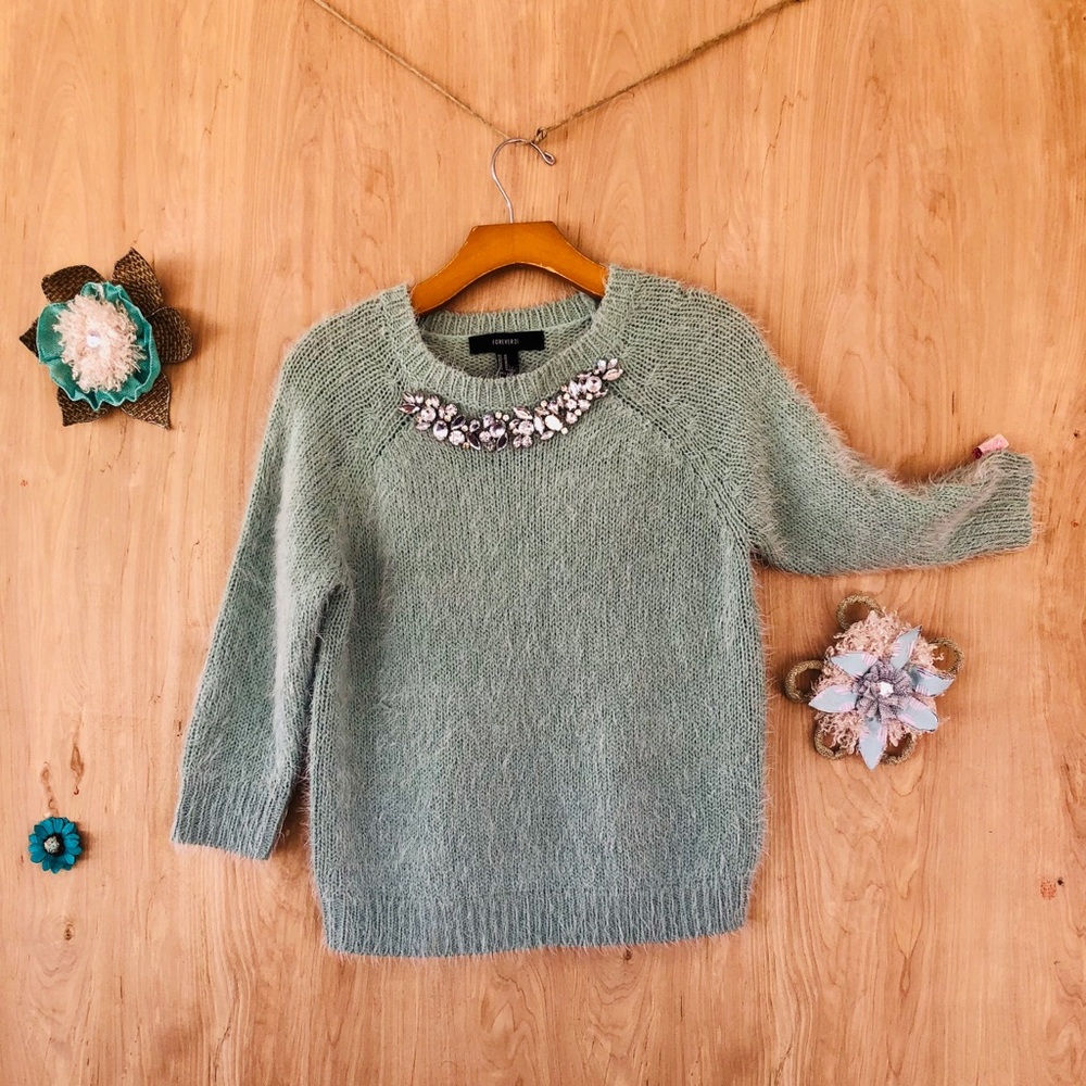A light teal, soft mid sleeve shirt.
